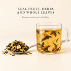Real fruit, herbs and whole leaves: a spoon of Boteane loose leaf tea beside a glass mug where you can see the leaves and fruit pieces you are drinking.