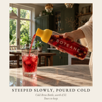 Boteane Ice Tea Cold Brew Bottle with a yellow stopper, filled with red hibiscus cold brew beside a glass of iced tea. Steeped slowly, poured cold. Included with the Welcome Box, worth £32, yours to keep.