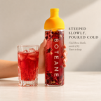 Boteane Ice Tea Cold Brew Bottle in the studio, filled with red hibiscus cold brew. Steeped slowly, poured cold. Included with the Welcome Box, worth £32, yours to keep.
