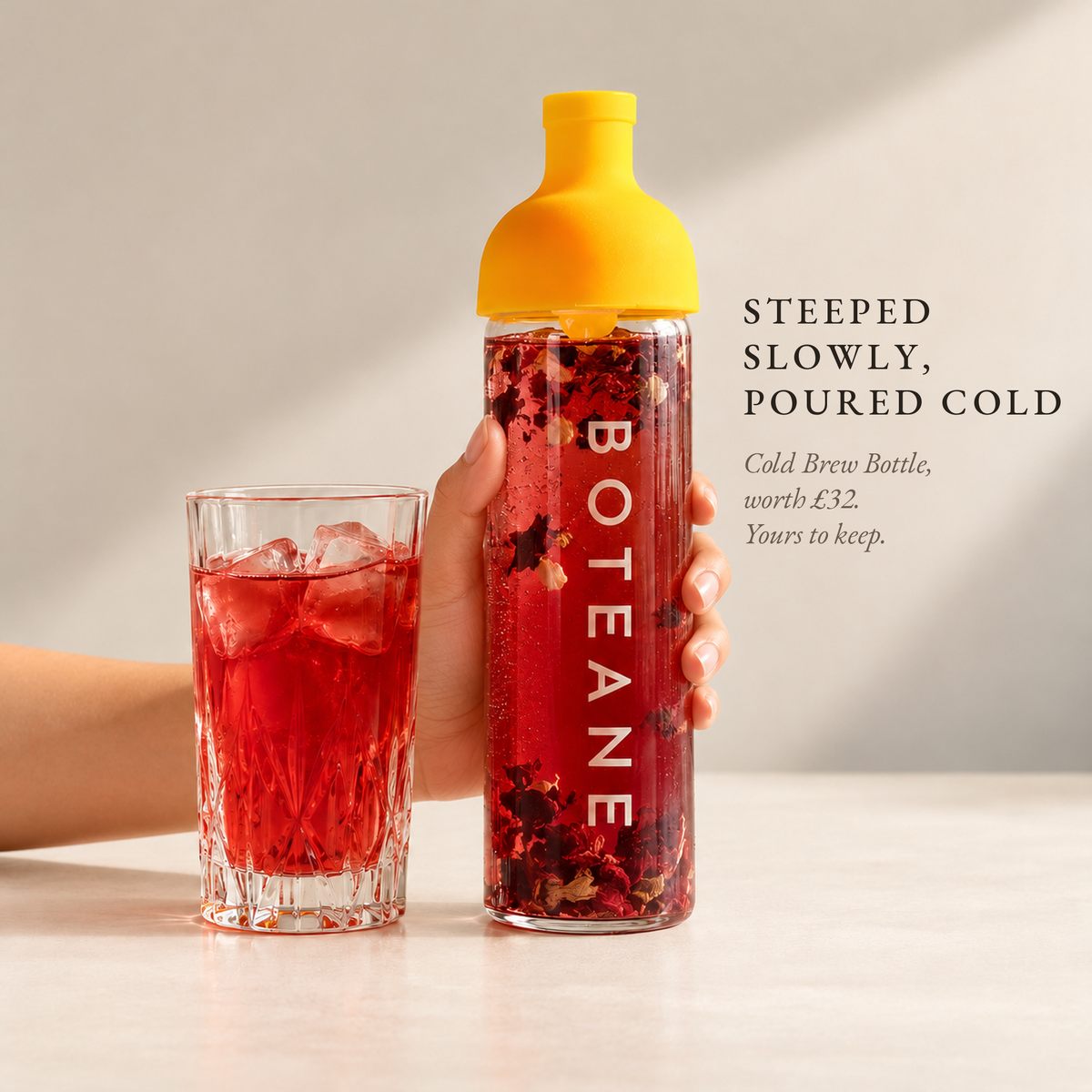Boteane Ice Tea Cold Brew Bottle in the studio, filled with red hibiscus cold brew. Steeped slowly, poured cold. Included with the Welcome Box, worth £32, yours to keep.