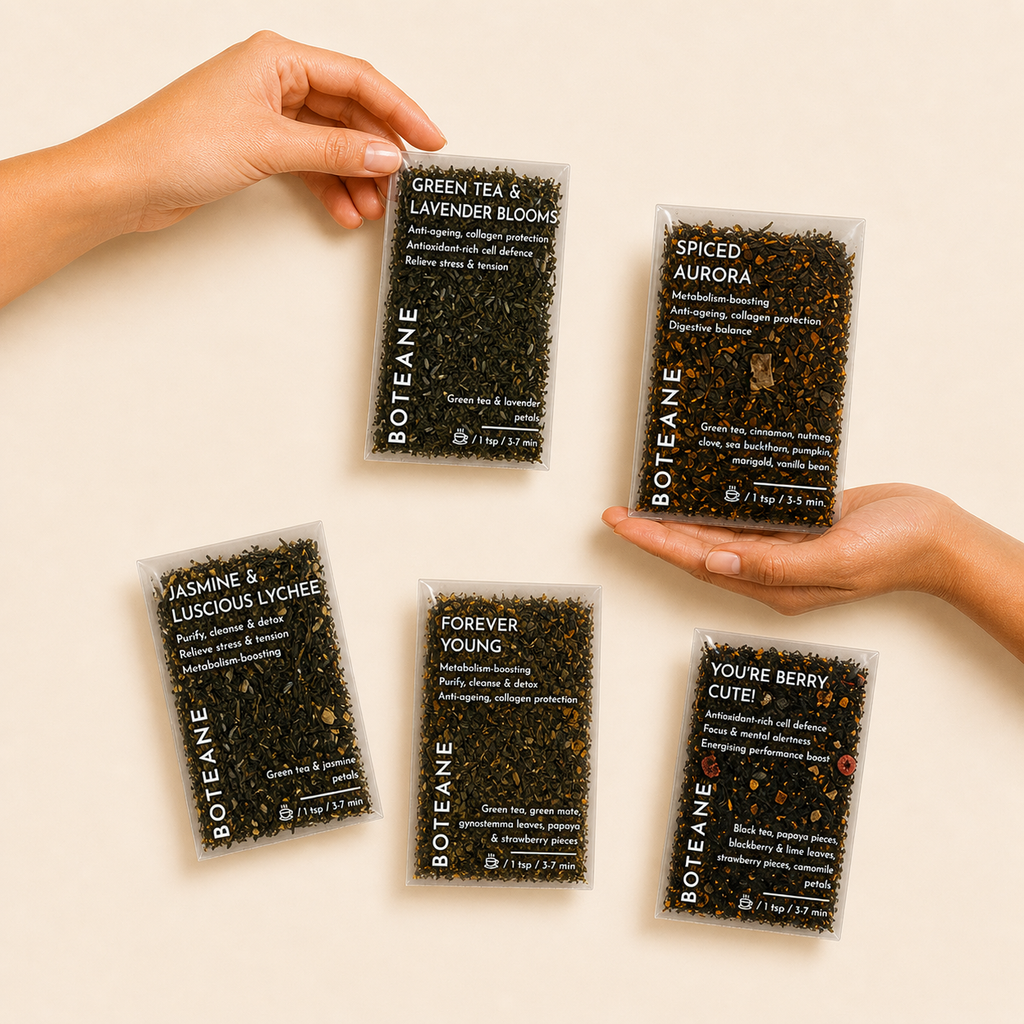 Boteane product packages with hands holding them against a beige background