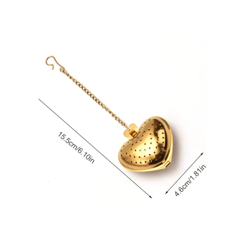Gold heart-shaped tea infuser with chain, shown with measurements on a white background