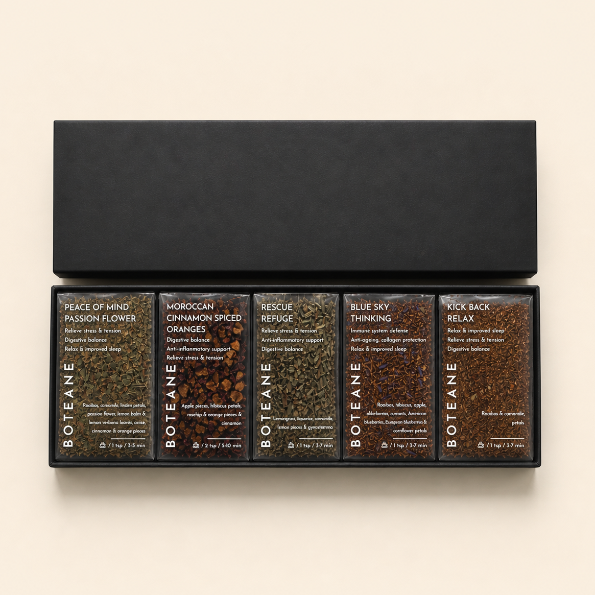 Set of Boteane tea boxes with various flavors on a beige background