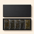 Set of Botane tea packages in a black box on a beige background