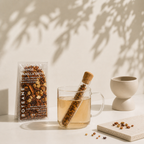 Boteane Orange Vanilla Grove tea packaging with a glass of tea and tea leaves on a light surface.