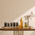 Table with Botane products including a bottle, jars, and a glass on a neutral background