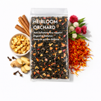 Tea package labeled 'Heirloom Orchard' with tea leaves, flowers, and spices on a white background