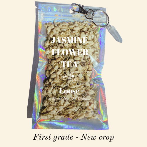 Jasmine flower tea package with loose tea leaves on a beige background